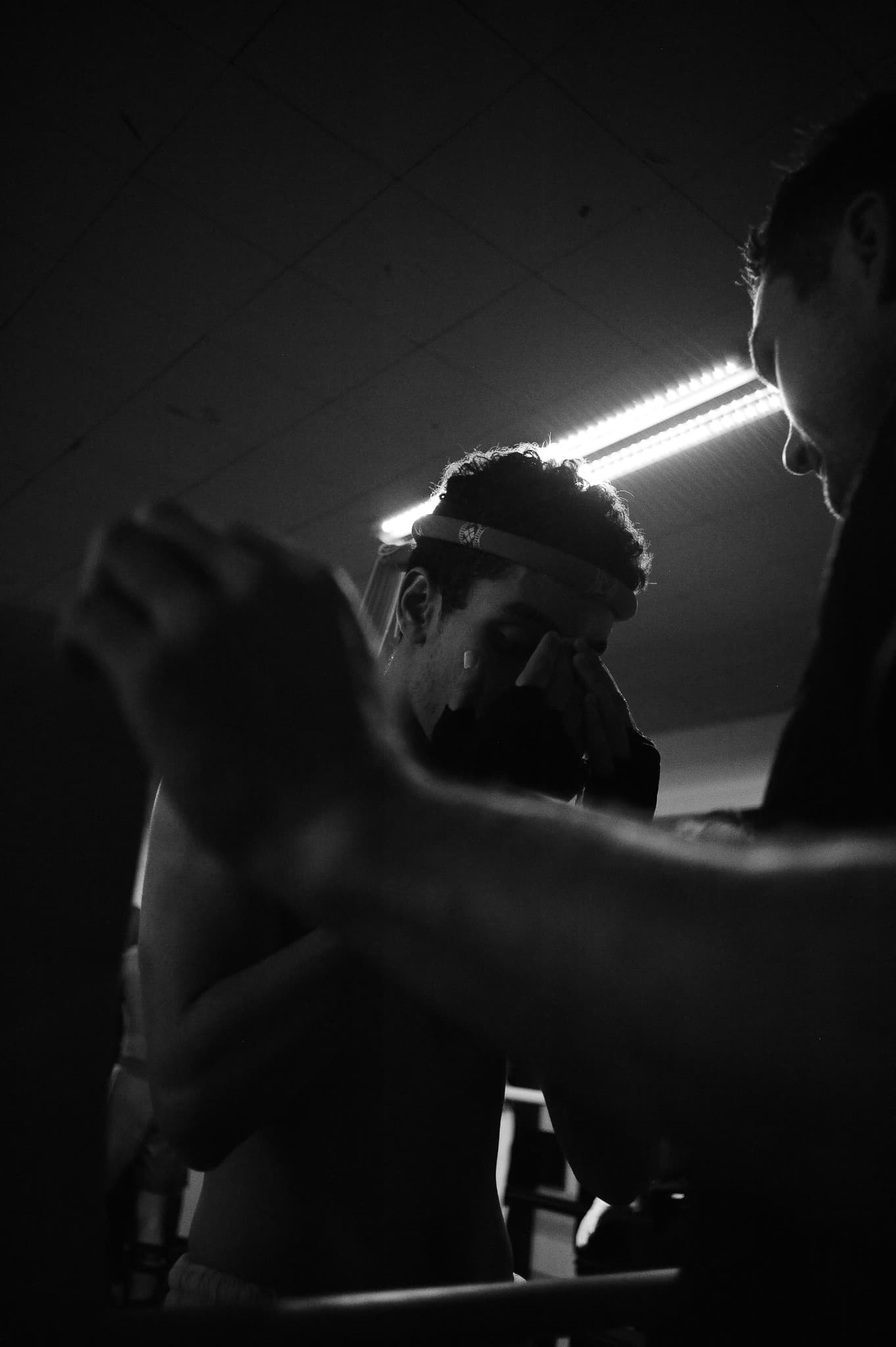 Muay Thai sparring session under dramatic lighting